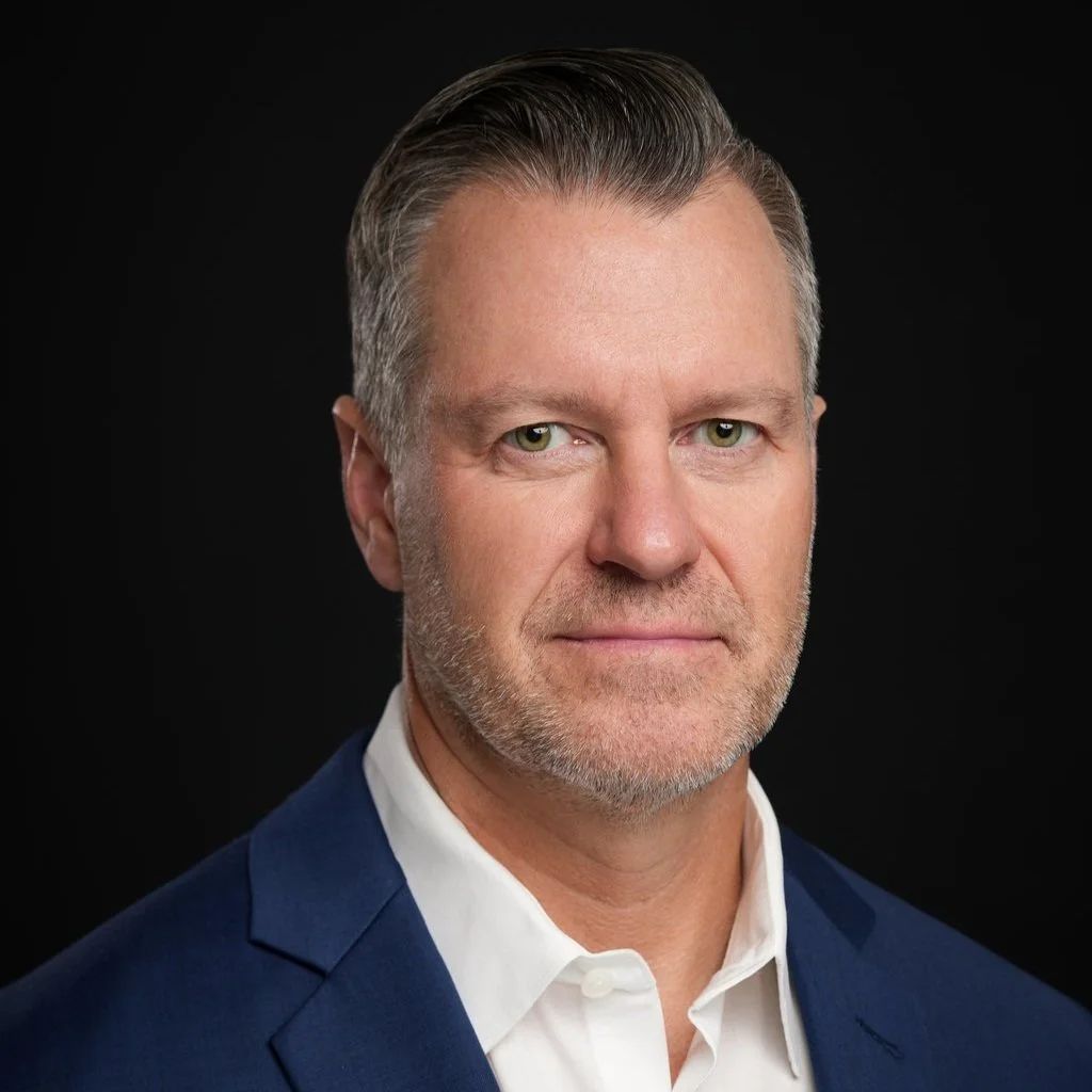 Corporate headshot of a man in a navy suit near University Avenue in Palo Alto, California