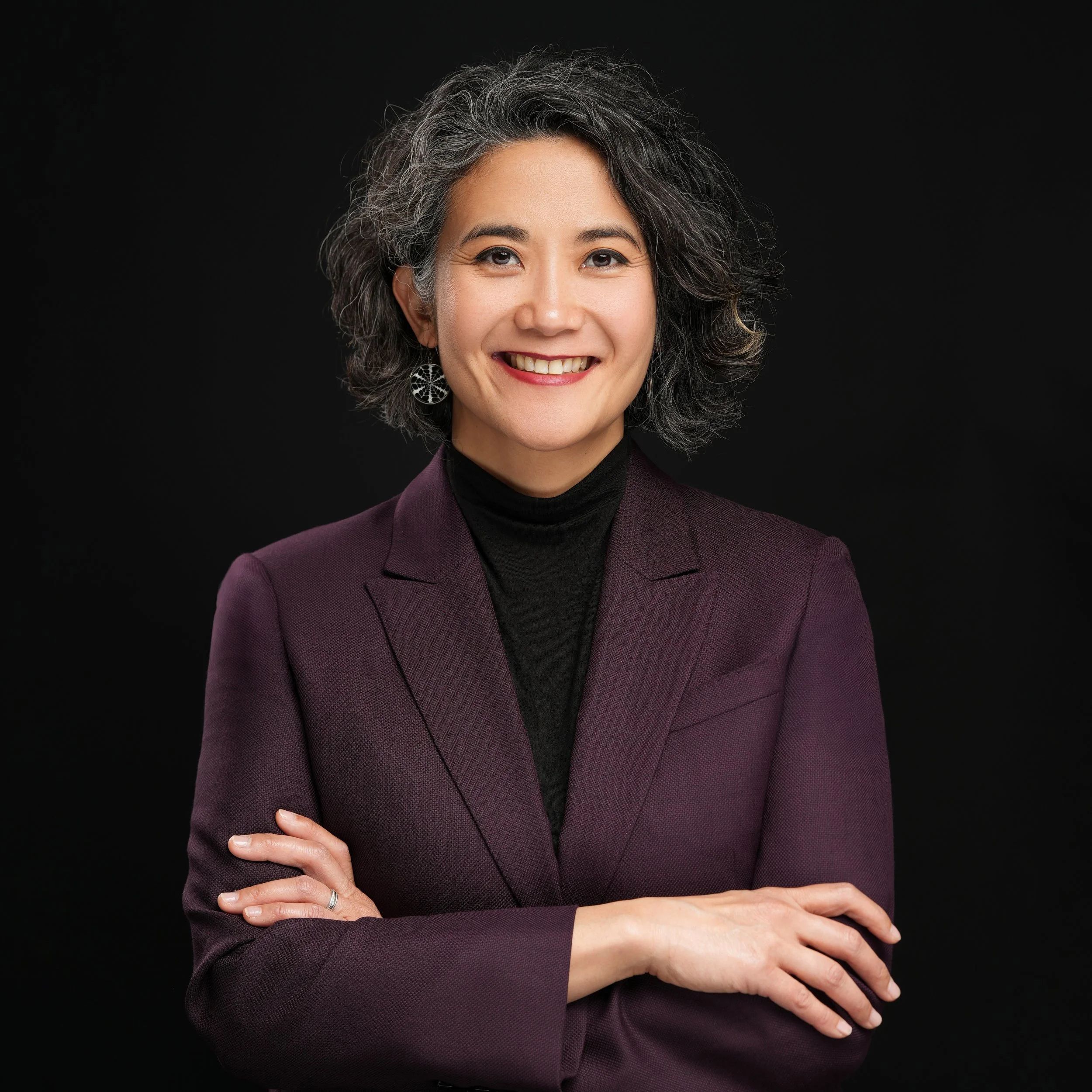Professional headshot of a woman in a burgundy blazer photographed on Castro Street in Mountain View, California